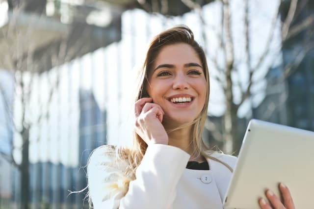 woman holding tablet and on the phone