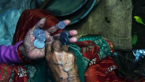 old woman hands counting small change poverty