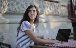 Young woman workin on laptop Gender Gap youth