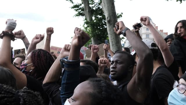 people protesting on the streets with arms up and fist Institute