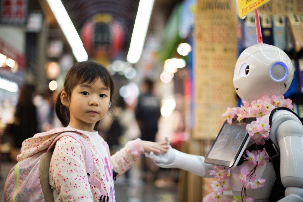 Youg girl holding hands with Ai robot